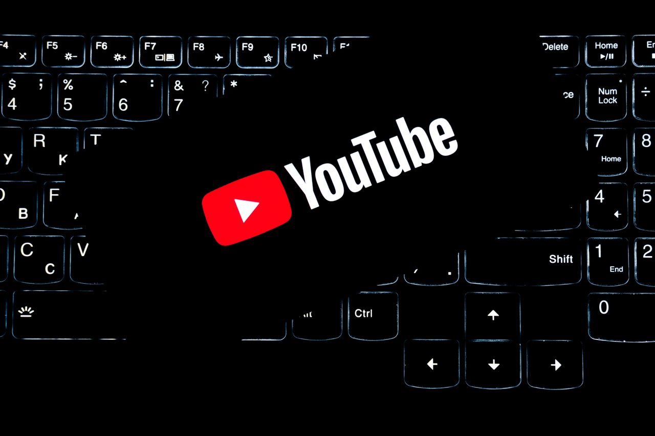 services-04 YouTube logo displayed on a backlit keyboard, representing digital media and online content creation.
